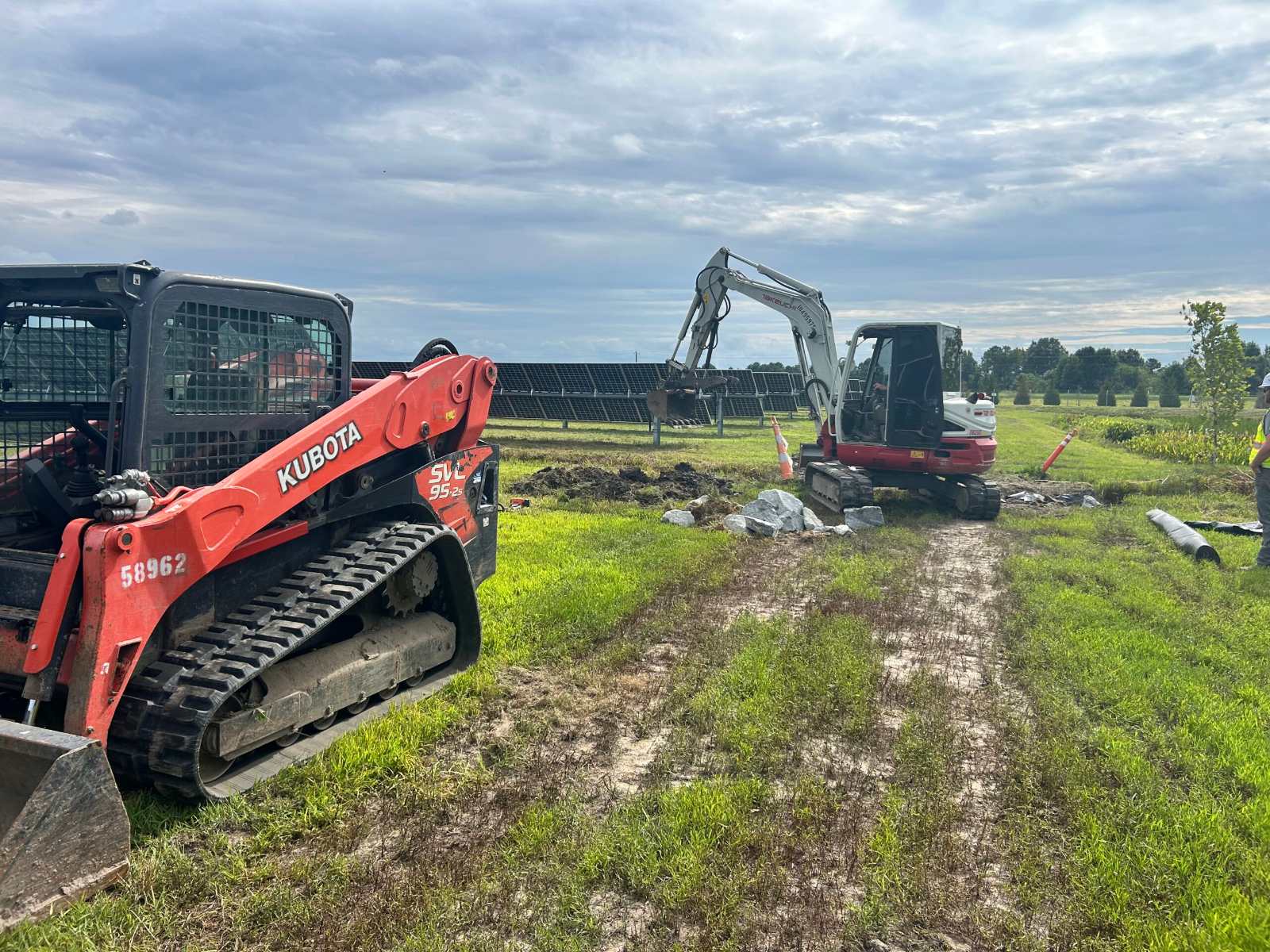 Ives compact track loader clearing vegetation at a solar site